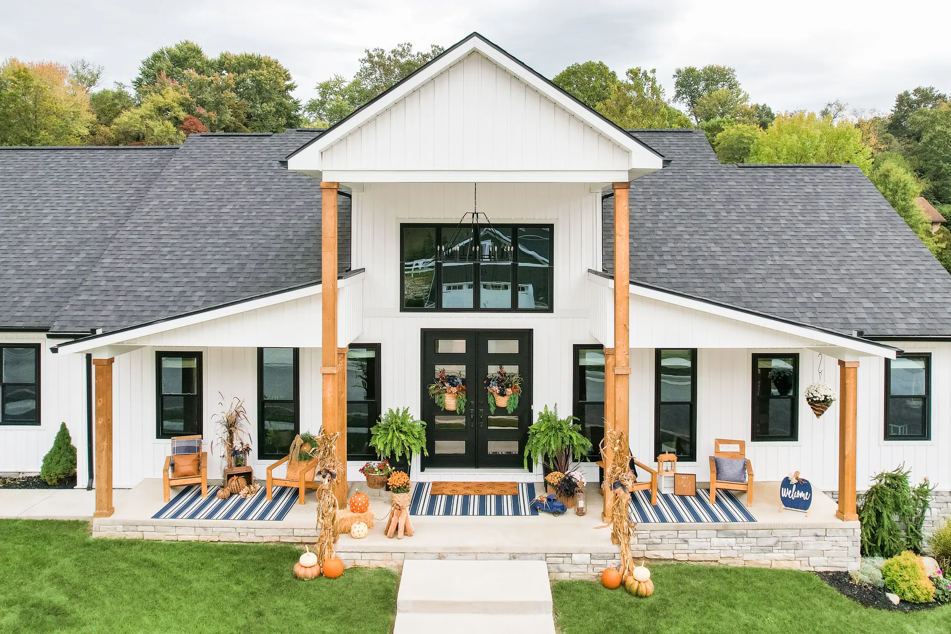 White farmhouse exterior with a black front door