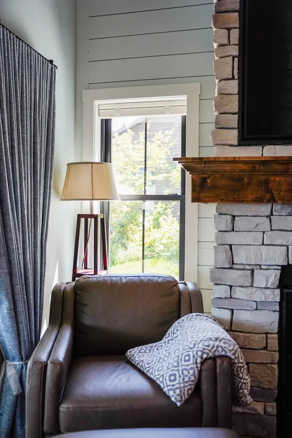 Double-hung window beside a living room fireplace